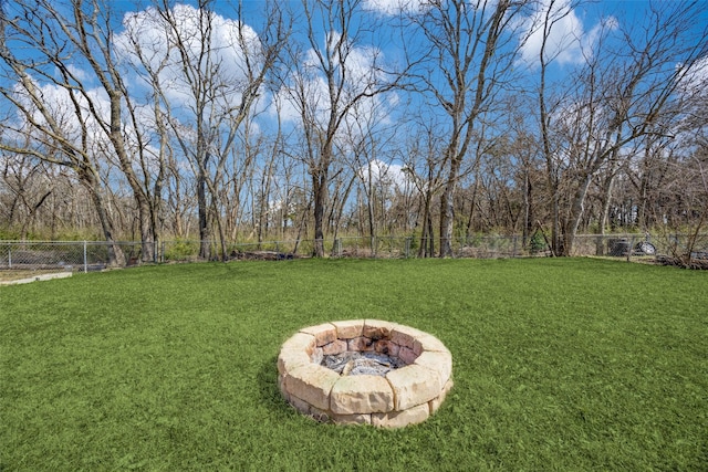 view of yard with fence and a fire pit