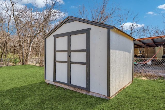 view of shed with fence