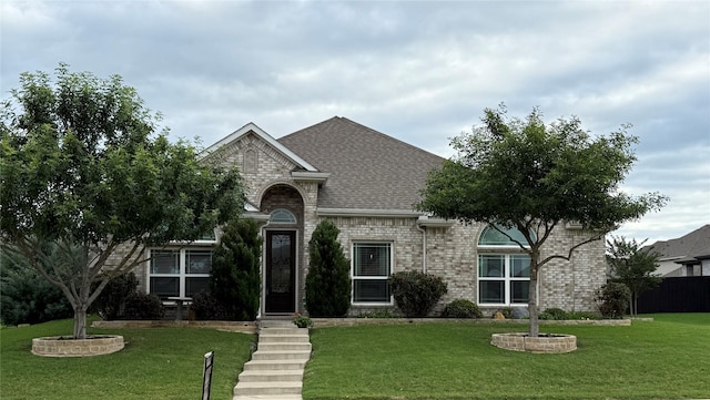 455 Wintergreen Dr, Waxahachie, TX 75165 - french country inspired facade with brick siding, roof with shingles, and a front yard