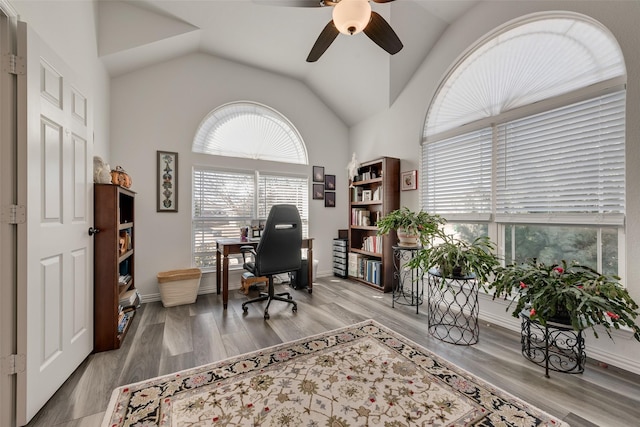 home office featuring ceiling fan, vaulted ceiling, baseboards, and wood finished floors