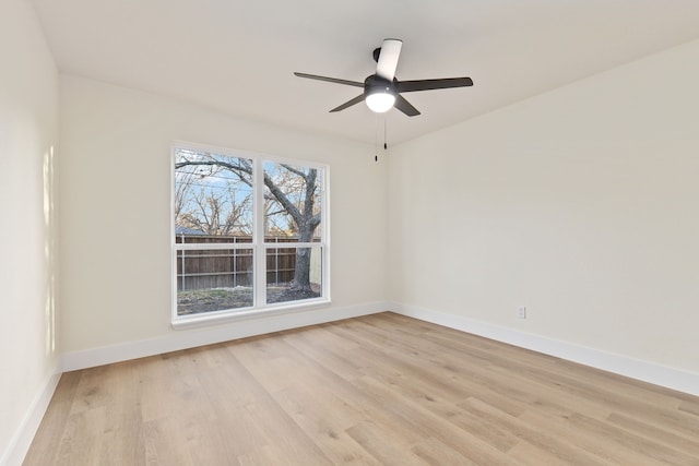 unfurnished room with a ceiling fan, baseboards, and light wood finished floors