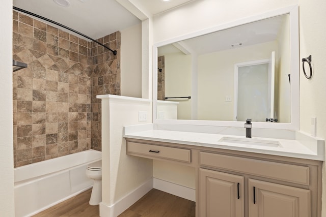 bathroom with visible vents, shower / bathing tub combination, toilet, vanity, and wood finished floors