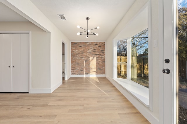 unfurnished sunroom featuring a chandelier and visible vents