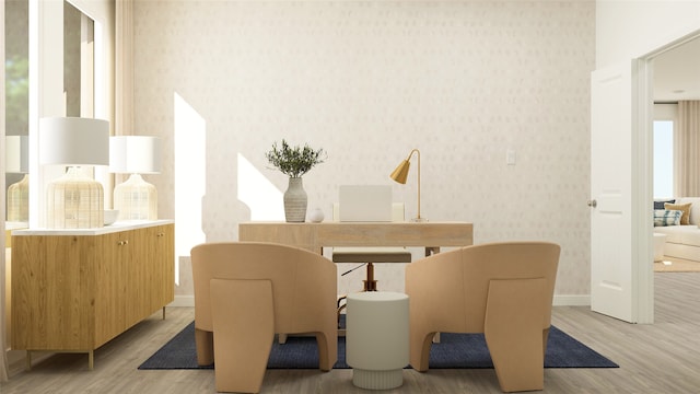 dining room featuring baseboards, light wood-type flooring, and wallpapered walls