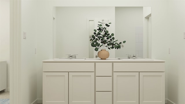 full bath with double vanity, baseboards, and a sink