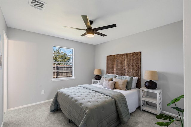 carpeted bedroom with baseboards, visible vents, and ceiling fan