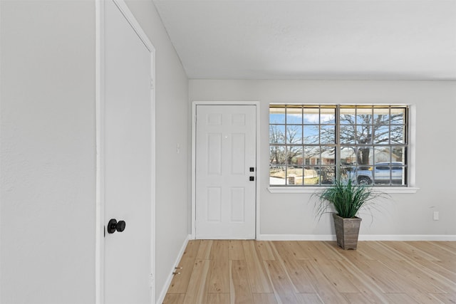 entrance foyer featuring light wood finished floors and baseboards