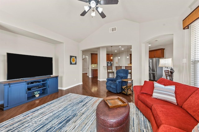 living room with lofted ceiling, arched walkways, dark wood-type flooring, visible vents, and a ceiling fan