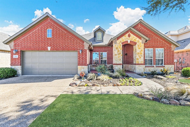 view of front of house with brick siding, a front yard, a garage, stone siding, and driveway