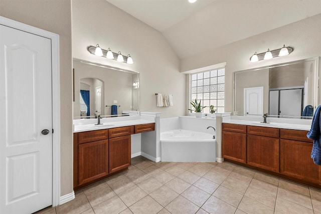 full bath with lofted ceiling, a sink, and tile patterned floors