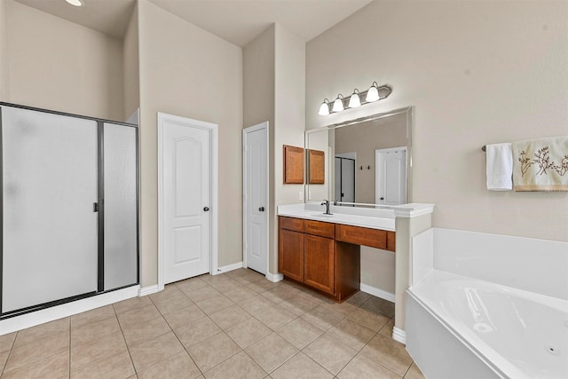 bathroom with vanity, a shower stall, a tub with jets, and tile patterned floors