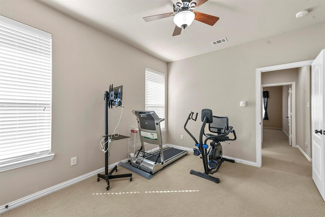 exercise room with ceiling fan, carpet floors, visible vents, and baseboards