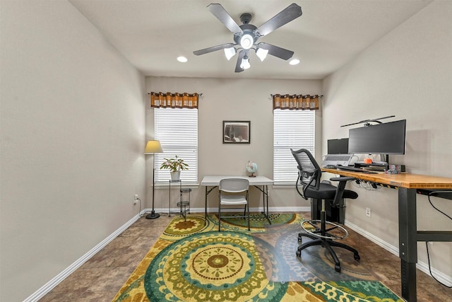 home office featuring a healthy amount of sunlight, ceiling fan, and baseboards