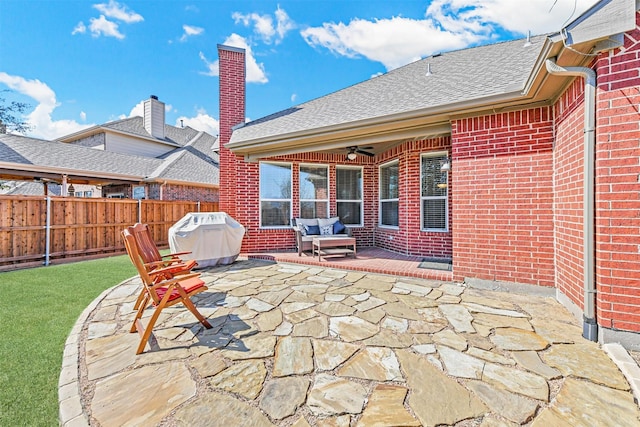 view of patio featuring fence, area for grilling, and ceiling fan