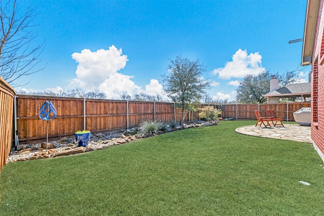 view of yard with a fenced backyard and a patio