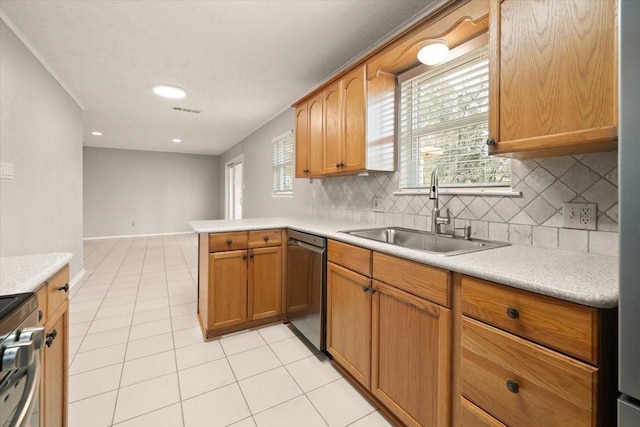 kitchen with light countertops, stainless steel dishwasher, light tile patterned flooring, a sink, and range