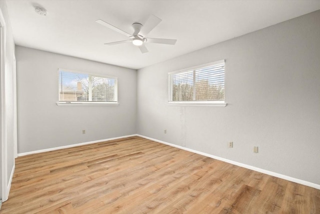 unfurnished room with baseboards, ceiling fan, and light wood finished floors