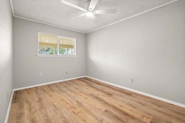 empty room with ornamental molding, baseboards, light wood-style flooring, and a textured ceiling