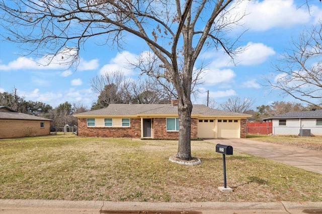 ranch-style house featuring a garage, brick siding, fence, driveway, and a front lawn