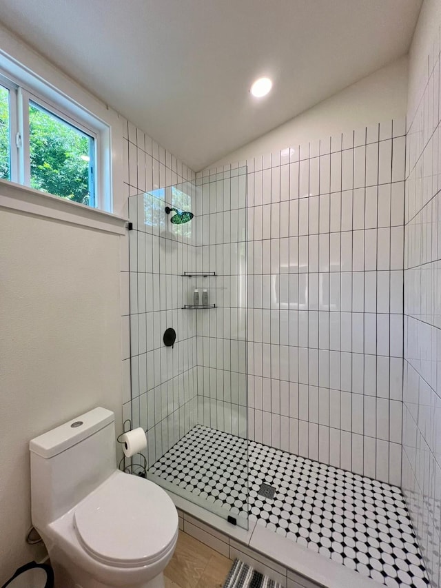 bathroom with a walk in shower and toilet