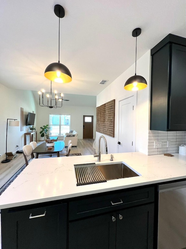 kitchen featuring dishwasher, visible vents, open floor plan, and dark cabinets