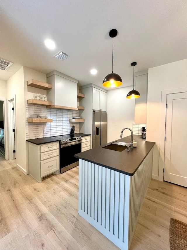 kitchen with dark countertops, visible vents, appliances with stainless steel finishes, and open shelves