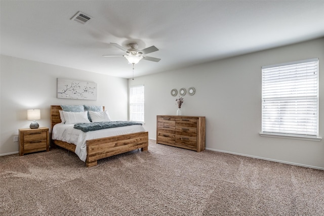 bedroom with carpet floors, multiple windows, and visible vents