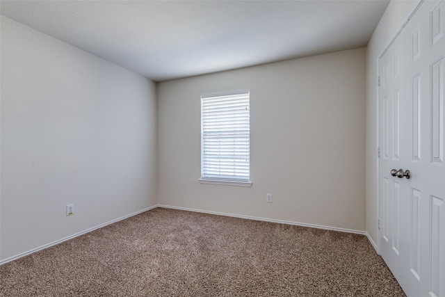 unfurnished room featuring carpet flooring