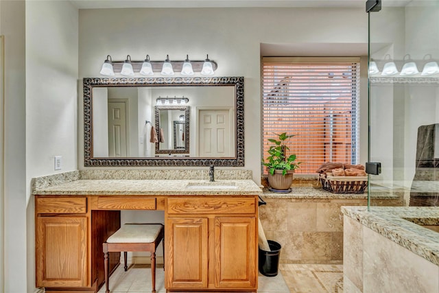 full bathroom with vanity, tiled shower, and tile patterned floors