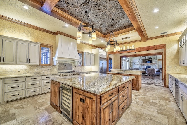 kitchen featuring wine cooler, stone tile floors, decorative backsplash, and custom range hood