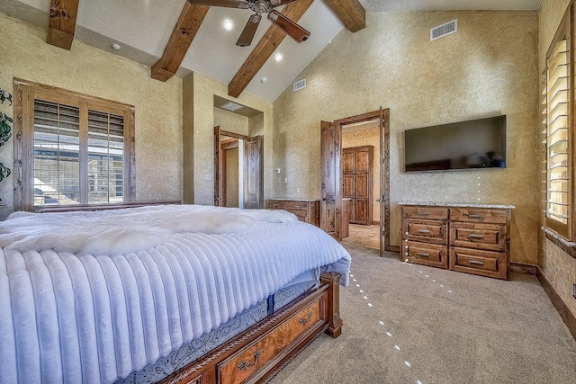 bedroom featuring beam ceiling, multiple windows, and visible vents