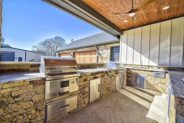 view of patio with an outdoor kitchen, area for grilling, and a sink