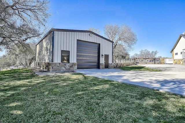 garage featuring driveway and fence