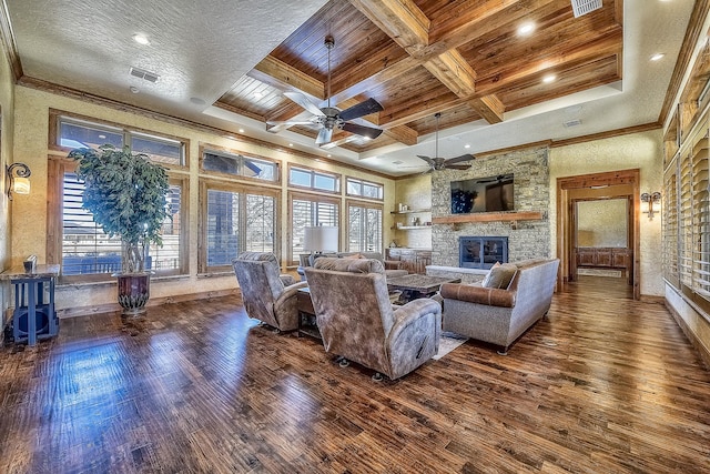 living area with a fireplace, ornamental molding, coffered ceiling, and wood finished floors