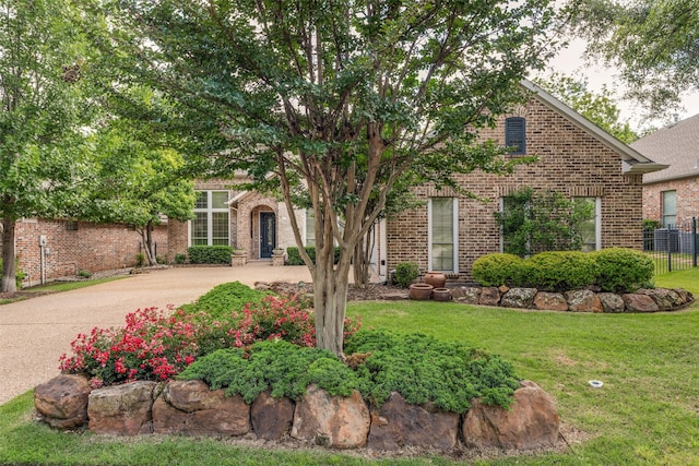 1313 Stoneoak Dr, Mckinney, TX 75072 - view of property hidden behind natural elements with brick siding and driveway