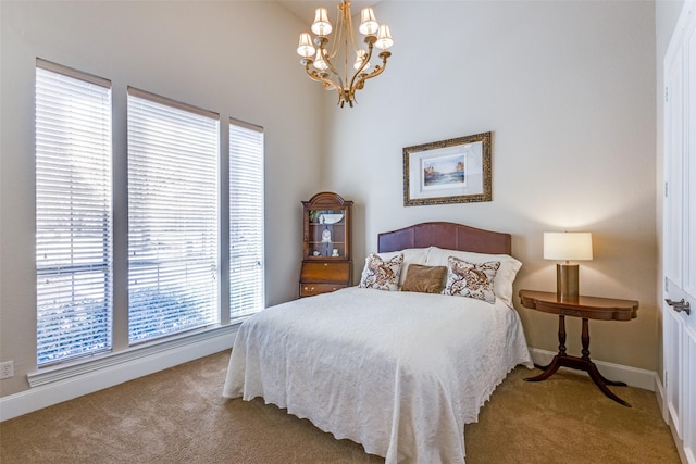 bedroom with baseboards, carpet flooring, and a notable chandelier