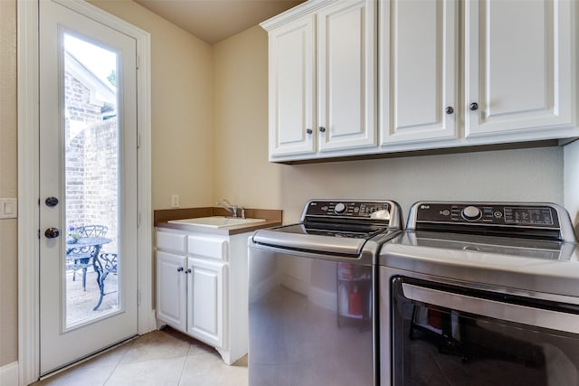 1313 Stoneoak Dr, Mckinney, TX 75072 - laundry area featuring cabinet space, washing machine and clothes dryer, and light tile patterned floors