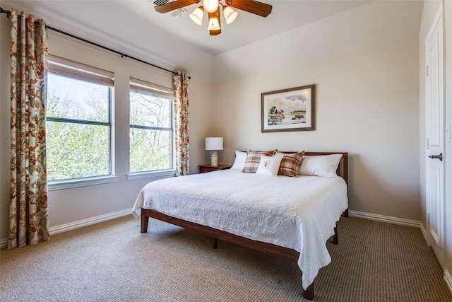 carpeted bedroom with ceiling fan and baseboards