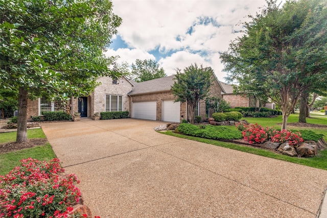 1313 Stoneoak Dr, Mckinney, TX 75072 - obstructed view of property with an attached garage, concrete driveway, brick siding, and a front lawn