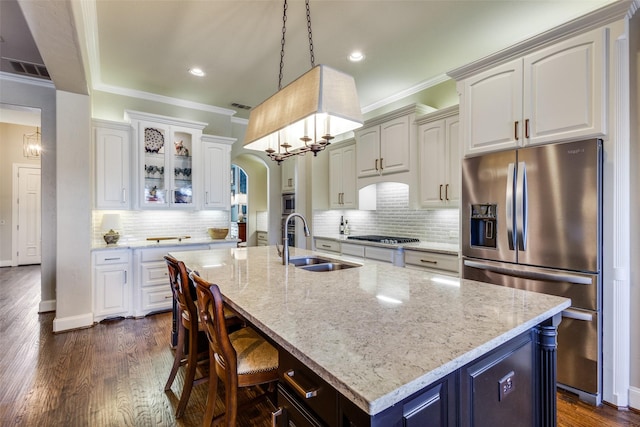1313 Stoneoak Dr, Mckinney, TX 75072 - kitchen with appliances with stainless steel finishes, a sink, crown molding, backsplash, and arched walkways