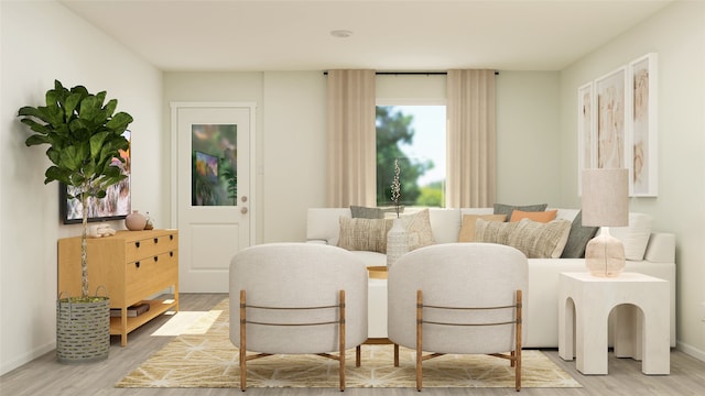 sitting room with light wood-type flooring and baseboards