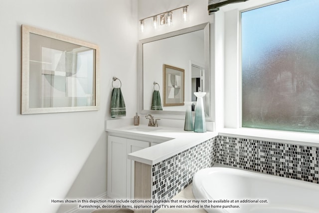 bathroom featuring vanity and a tub