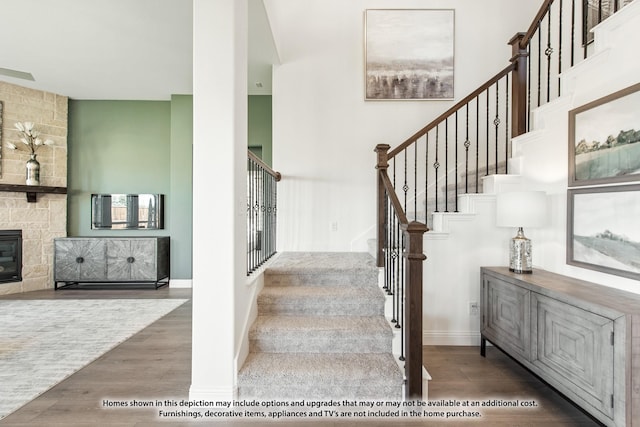 stairway featuring baseboards and wood finished floors