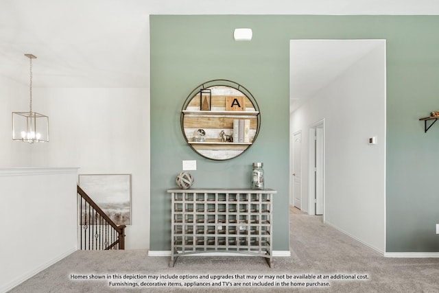 hall with baseboards, carpet flooring, an upstairs landing, and a notable chandelier