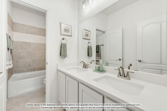 bathroom featuring tile patterned floors, a sink, toilet, and double vanity