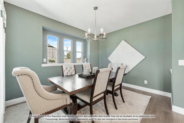 dining area with an inviting chandelier, baseboards, and wood finished floors