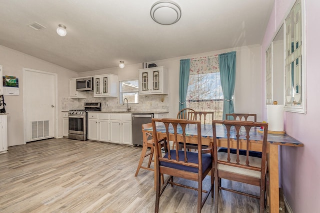 dining room with visible vents and light wood-style flooring