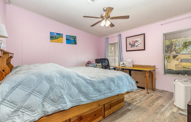 bedroom with ceiling fan and light wood-style floors