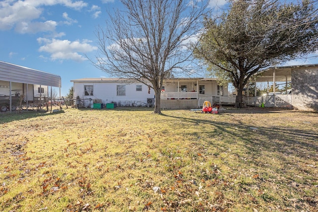 rear view of property with a lawn