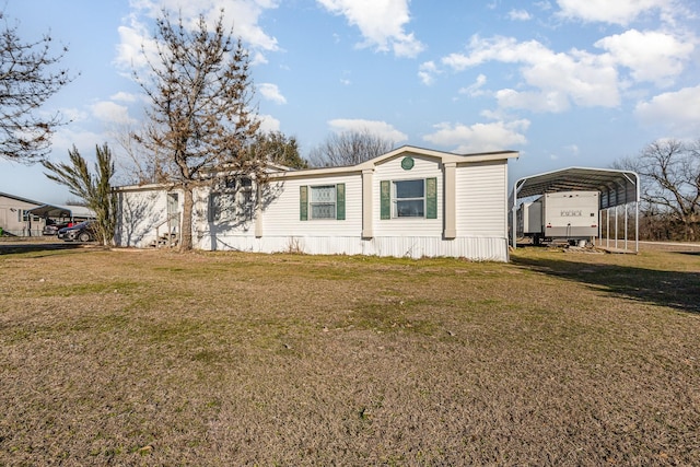 view of front facade with a carport and a front yard